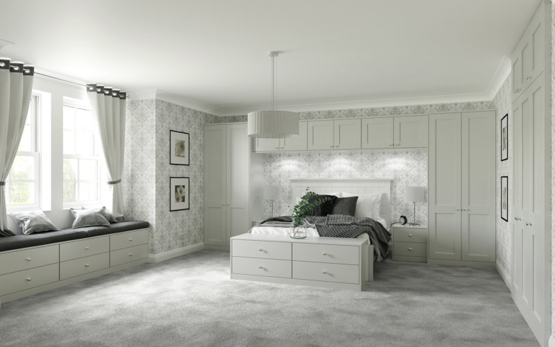 Classic styled bedroom with built in cupboard surrounding the bed. With drawers at the end of the bed. All painted light grey.