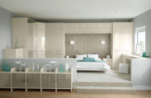Modern bedroom with gloss cupboard surrounding the bed which consists of cupboards, bed side tables and dressing table