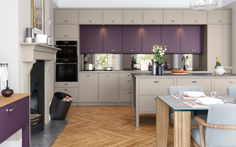 Dark beige cabinets that run the whole length and height of the kitchen wall, there is also purple cabinets within the structure of the large cabinet wall. Matching island to the dark beige and a matching purple draw set to the left of the image.