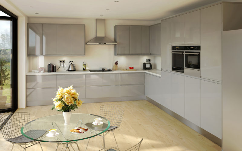 Modern grey gloss kitchen with white counter top. Integrated ovens and hob with metal extractor fan over head.