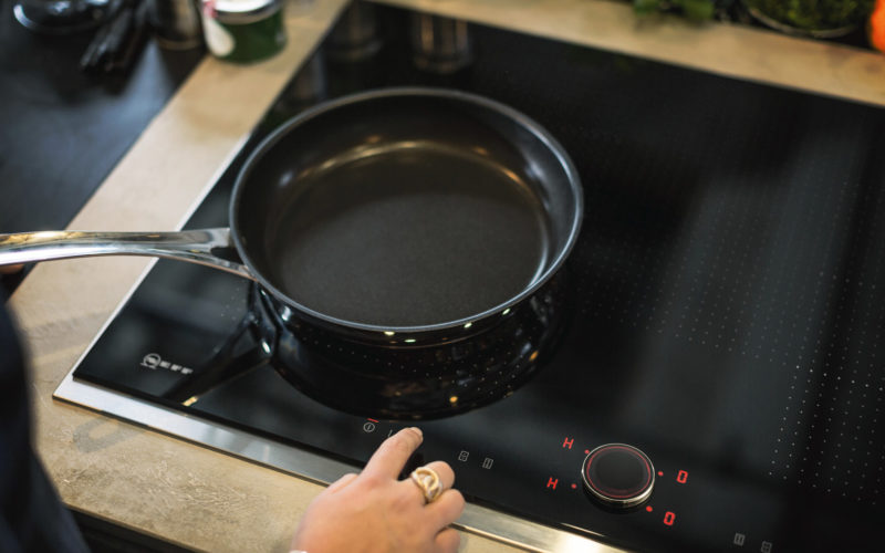 NEFF hob with someone using the digital dials