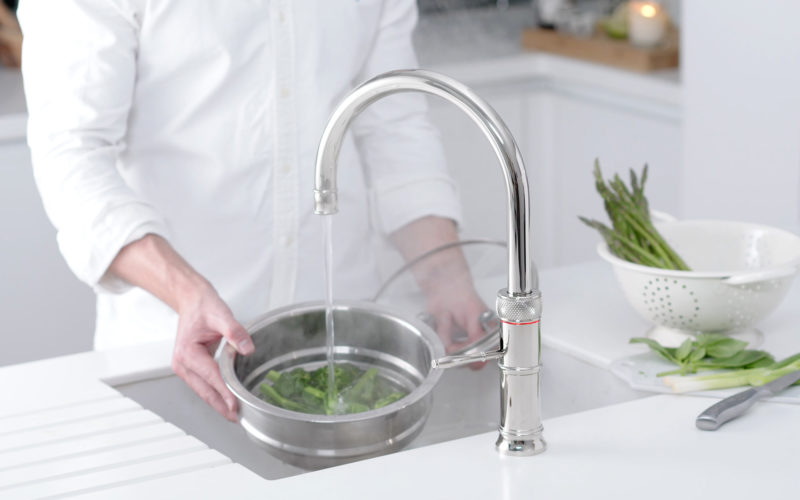 Quooker hot top showing boiling water coming straight from the tap into a bowl of vegetables