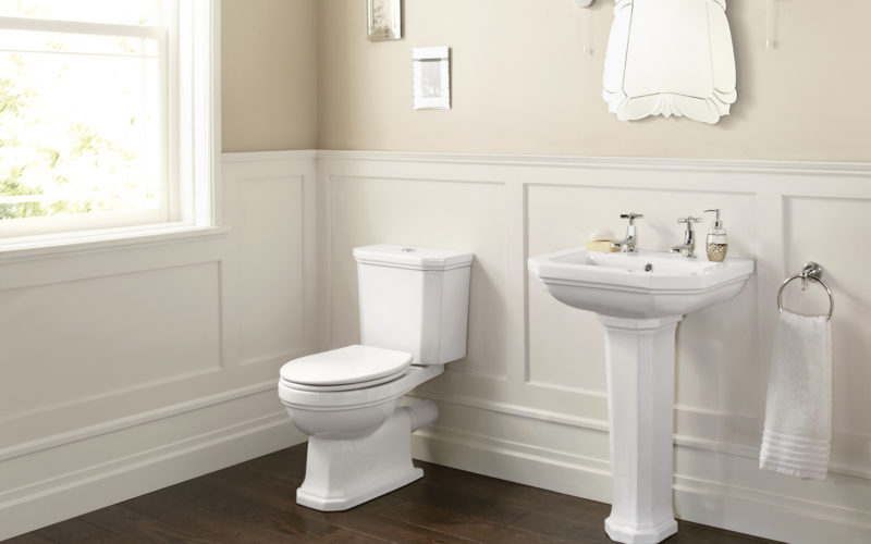White toilet and sink with panel mouldings