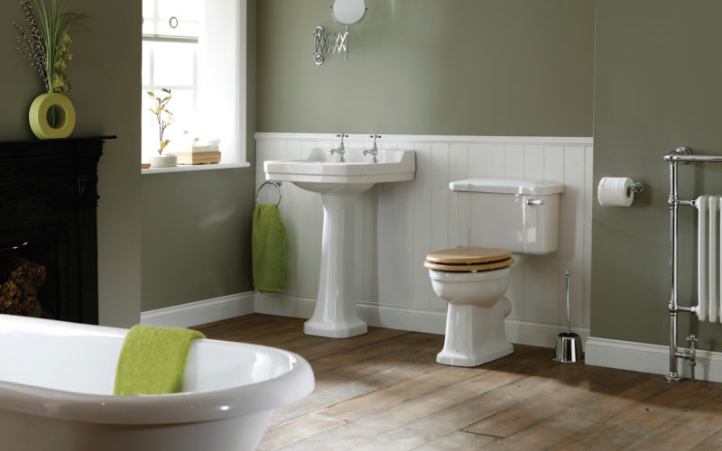 Holborn bathroom featuring a white toilet, sink and bathtub with sage coloured walls