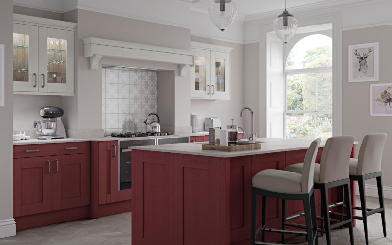 Colourful classic kitchen showcasing a red island with matching units by the oven