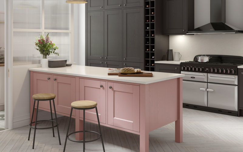 Rose coloured island with white top in a black cabinet kitchen